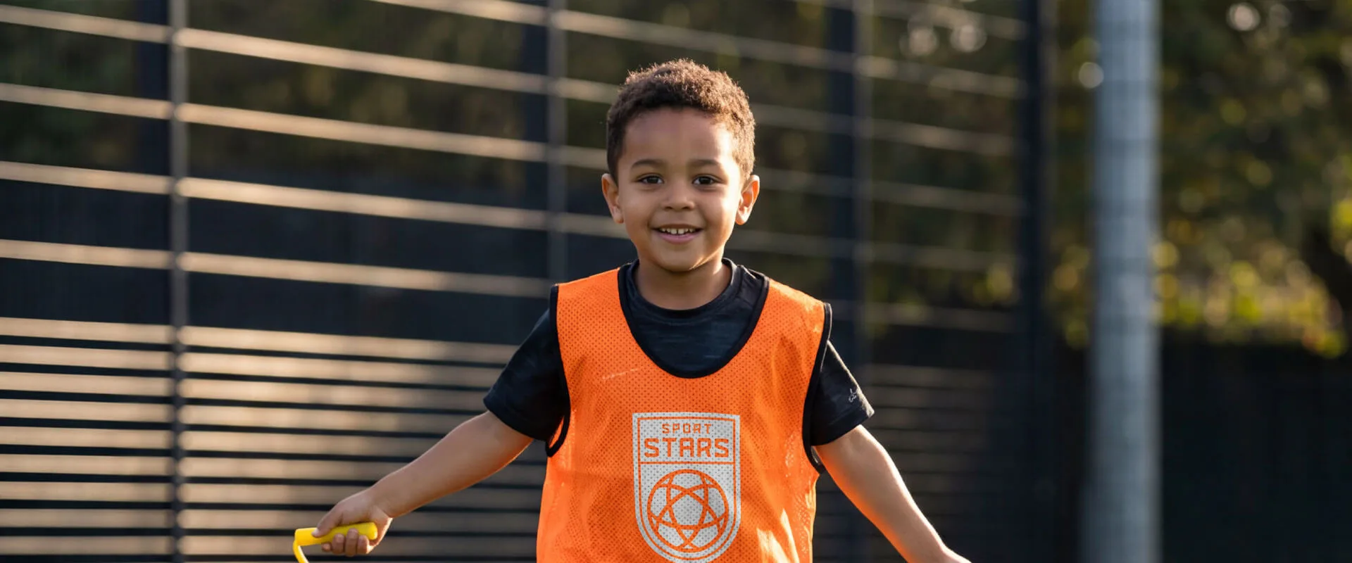 Young child playing basketball during a HoopStars summer camp in the GTA
